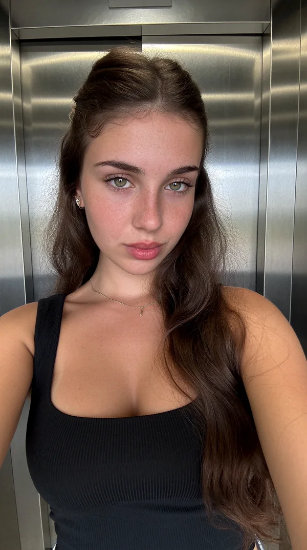 Starting reference: a brunette AI character taking a selfie